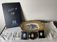 Photo showing all four pieces: three framed cameo miniatures and one vintage decorative plate with floral design and ornate handles.