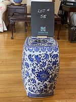 Full view of the chinoiserie ceramic side table with the lot number visible, showing its hexagonal shape and floral pattern.