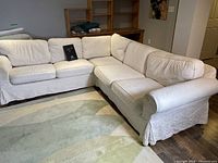 Front view of entire sectional showing slipcovers and overall shape