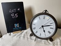 Photo of Pottery Barn clock styled as vintage pocket watch on small feet, showing front and side angles