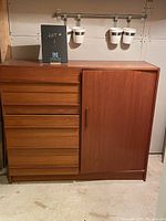 Angled front view showing drawers and cupboard