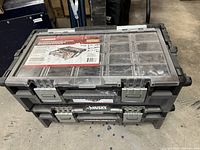 Stacked view of two closed Husky cantilever organizers showing brand and latches.