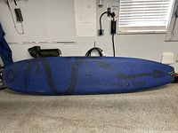 Blue top view of board showing black tribal graphics and text “Papa Upi”