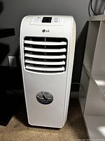 Front view of white LG portable AC unit showing vents and front panel