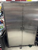 Front view of closed cabinet showing diamond plate doors and pull handles