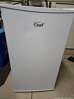 Front view of white Master Chef mini fridge with freezer showing logo on door.