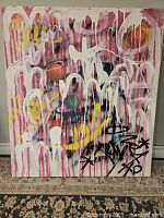 Frontal view of colorful abstract painting with dripping and spray paint elements, vibrant multicolor palette.