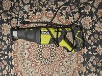 Full view of Ryobi cordless reciprocating saw showing overall condition and design.