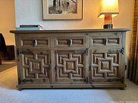 Front view showing four drawers over three decorative cabinet doors