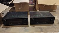 Two Denon receivers side by side front view