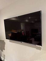 Front view of mounted TV showing entire screen and bezel.