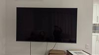 Front view of the 60-inch Samsung TV mounted on wall bracket