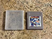Alleyway game cartridge displayed next to its clear protective case on a granite countertop.