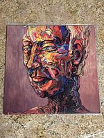 Front cover of Milo Greene vinyl record showing colorful abstract painted face artwork.