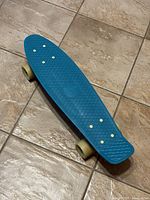 Top view of blue Penny Australia skateboard showing textured deck and size.
