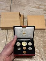 Royal Canadian Mint 1972 coin set in red presentation case with two cardboard outer sleeves visible behind case