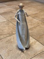 Front view of the Royal Doulton Reflections 'Debut' figurine showing full figure with long dress and cape detail.