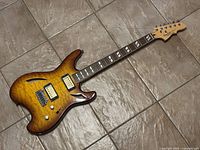 Full body shot of the VanSal Mod 1 electric guitar showing the sunburst quilted maple semi-hollow body with F-holes and hardware.