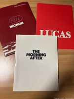 Press kit folders for Inchon (1982), Lucas, and The Morning After shown on a wood surface.