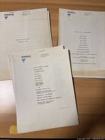 Typed production notes sheets on United Artists letterhead for films, shown on wooden surface.