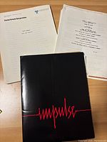 Photo showing typed production notes/scripts for Stay Hungry and Bound for Glory, and black booklet titled 'Impulse'