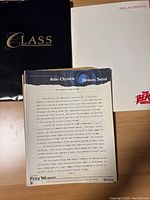 Photo showing three folders or packets: one labeled 'Class', white folder with 'Press Information', and a production note sheet titled 'Demon Seed' featuring Julie Christie and Fritz Weaver.