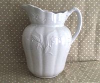 Full view of antique white ironstone jug showing front and handle