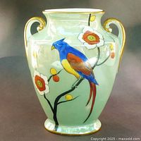 Front view of vase showing full parrot motif and floral decoration