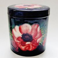 Front view of jar with lid on, showing full floral design