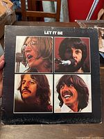 Front cover of 'Let It Be' album by The Beatles showing the four band members' faces in four squares.