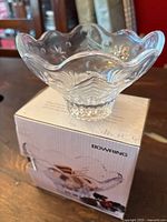 Clear glass candy bowl with decorative embossed tree and star patterns visible on sides and base, shown on top of original Bowring branded box.