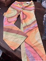 Full view of the Ragged jeans showing the funky multicolor retro wave pattern extending across legs.