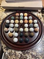 Game board with all the colored marble orbs arranged in the holes