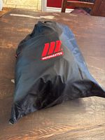Motomaster collapsible rooftop cargo bag in black with visible logo on front