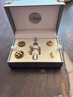 Box open showing base ring holder with 6 decorative ring caps arranged around a single base ring band.