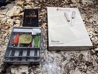 Maxwell Williams Mezze Hors D'oeuvres set box and Abbott Collection cheese spreaders box on marble surface.