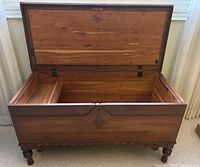 Open trunk showing interior cedar lining and carved front trim