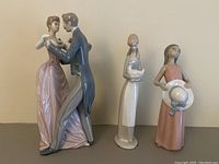 Three Lladro porcelain figurines: dancing couple, slender girl holding book, girl with hat.