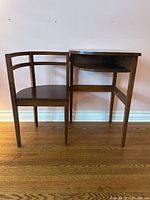 Front view of chair and table in open position showing curved chair back and table top