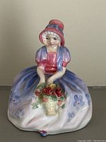 Front view of Royal Doulton Monica HN1467 figurine showing flower basket and clothing details
