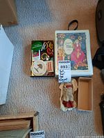 Photo showing all items together: Asian porcelain face doll, open box of buttons, and Dawn doll case.