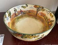 Top-down photo showing interior and design of ceramic bowl with pastoral scenes.