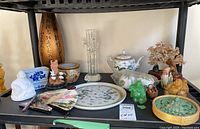 Wide view of the shelf displaying the full lot of Asian decorative items noted in the seller description.