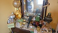 Wide view of candle collection on table including tealights, candle holders, and assorted decorative pieces.