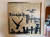 Full view of signed framed painting on canvas showing abstract birds and fence elements in black on textured off-white background.
