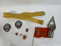Full lot overview showing parade belt, pins, cockade, red flag section, and metal flag topper
