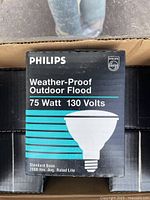 Box of Philips Weather-Proof Outdoor Flood 75 Watt 130 Volt bulbs with branding and product image on front.