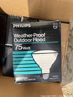 Front of box showing Philips branding, product name, wattage (75 Watt), image of bulb, and voltage (130 volts)