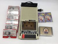 Califone 3430AV cassette recorder with assortment of dictation and music tapes in original cases displayed around the unit.