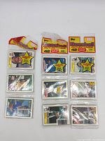 Front view of unopened packs of vintage Topps Baseball Picture Cards, displaying player images and pack branding.